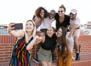 Young people are wearing Nöz colorful reef safe sunscreen on their nose, to express their personality in a fun and playful way ready to share with the world.