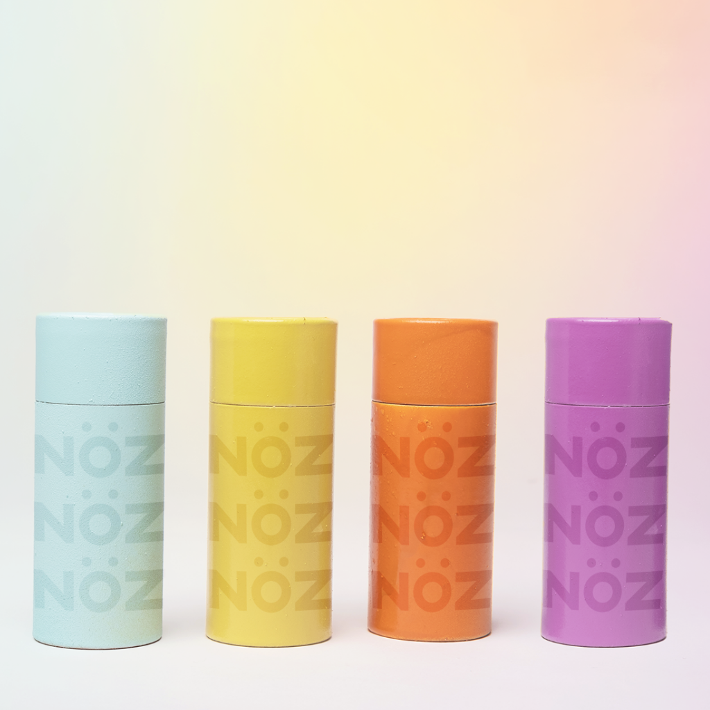 Nöz dermatologist tested, reef safe, vegan, and cruelty-free sunscreen collection in 4 different colors: blue, yellow, orange, and purple. 