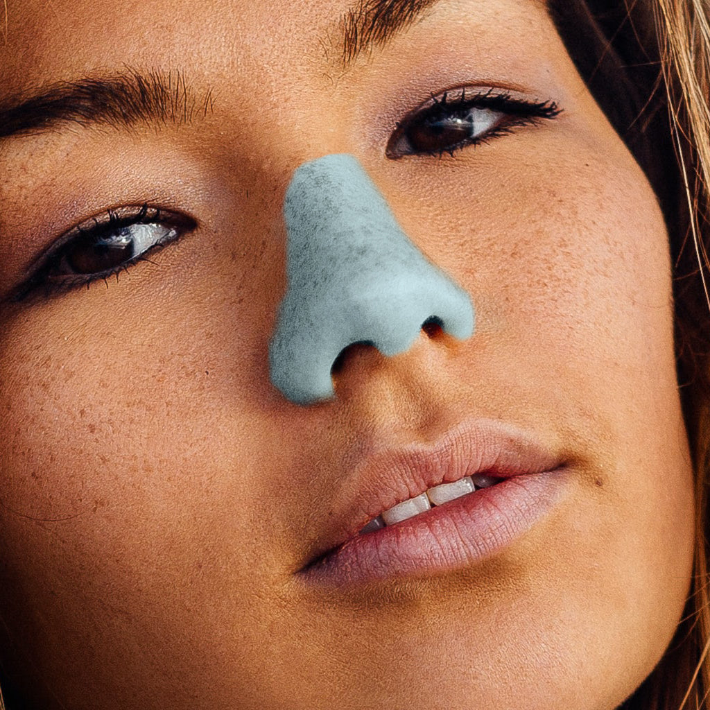 Model is wearing the colorful reef safe sunscreen on her nose, to express her personality in a fun and playful way ready to share with the world.